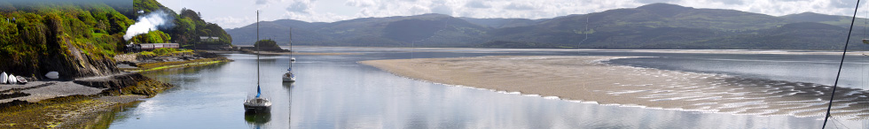 Steam train on the Cambrian Coast line alongside the Roman Walk